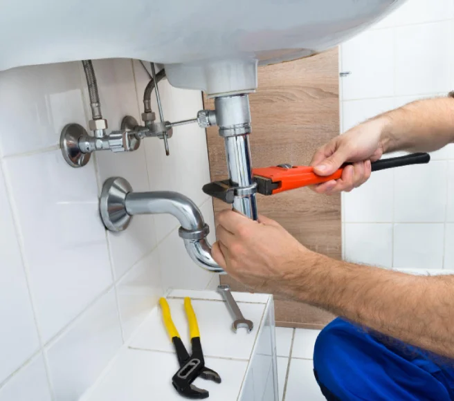 Plumber fixing a kitchen sink